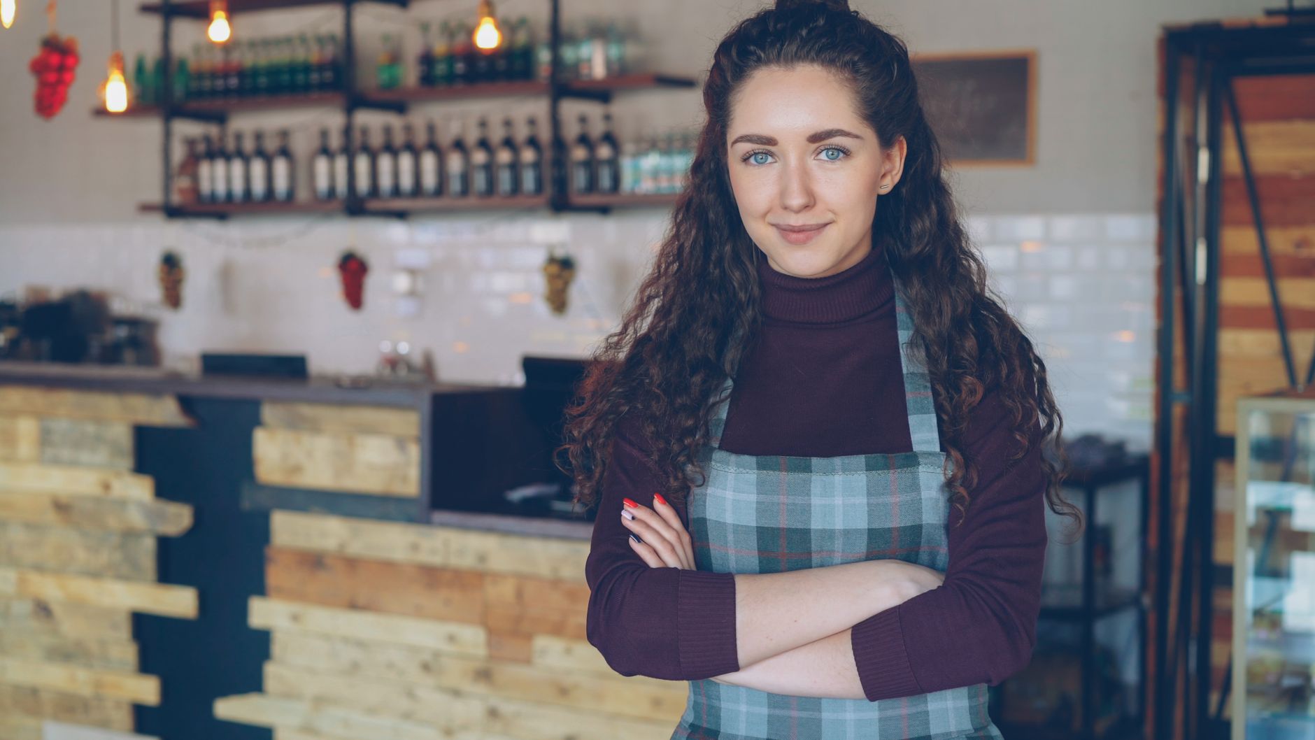 A cafe owner in their shop, the kind of small business each Frontier AirNode is matched to before it earns